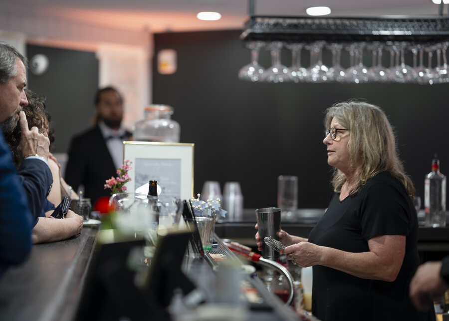 A bartender mixing cocktails for guests